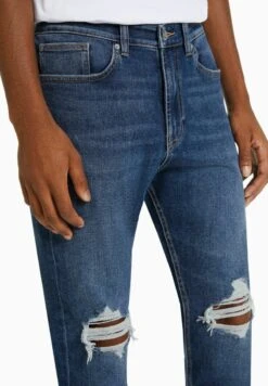 BERSHKA RIPPED CARROT FIT - Jeans Slim Fit - Dark Blue -Bershka Verkaufsgeschäft dd0faf2879b84bb6996ea0556b604204